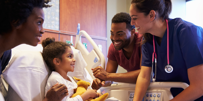 Pediatrician Visiting Parents And Child In Hospital Bed Pediatrician Visiting Parents And Child In Hospital Bed