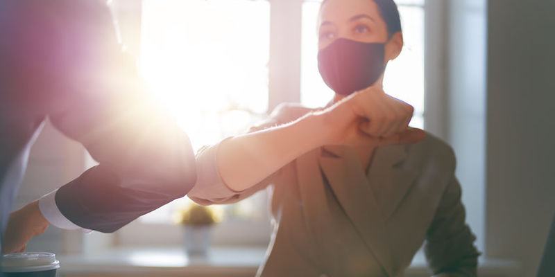 people working in office Businessman and businesswoman with medical mask working in office. Covid-19 time.